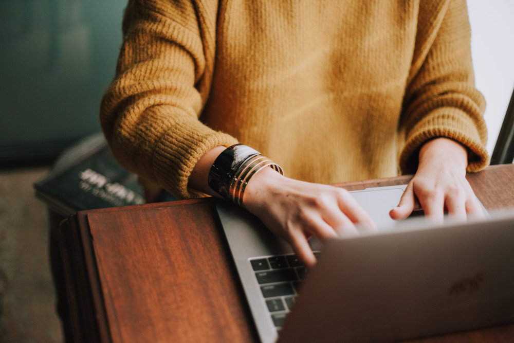 domain extension woman sitting with laptop