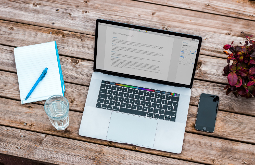 productivity tips taking notes and laptop