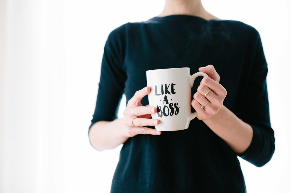 woman holding mug like boss