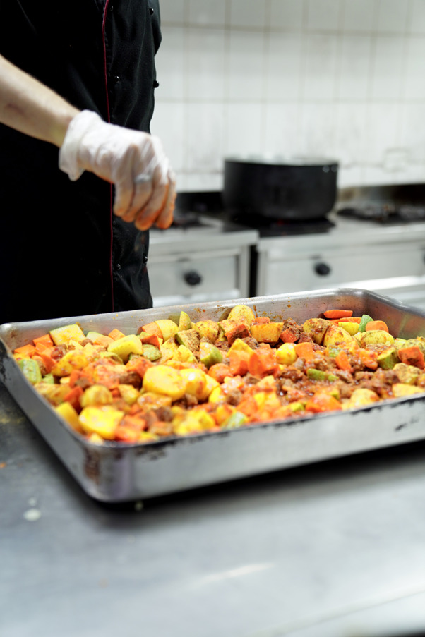 A chef preparing food at the kitchen of Qedrah w Mansaf