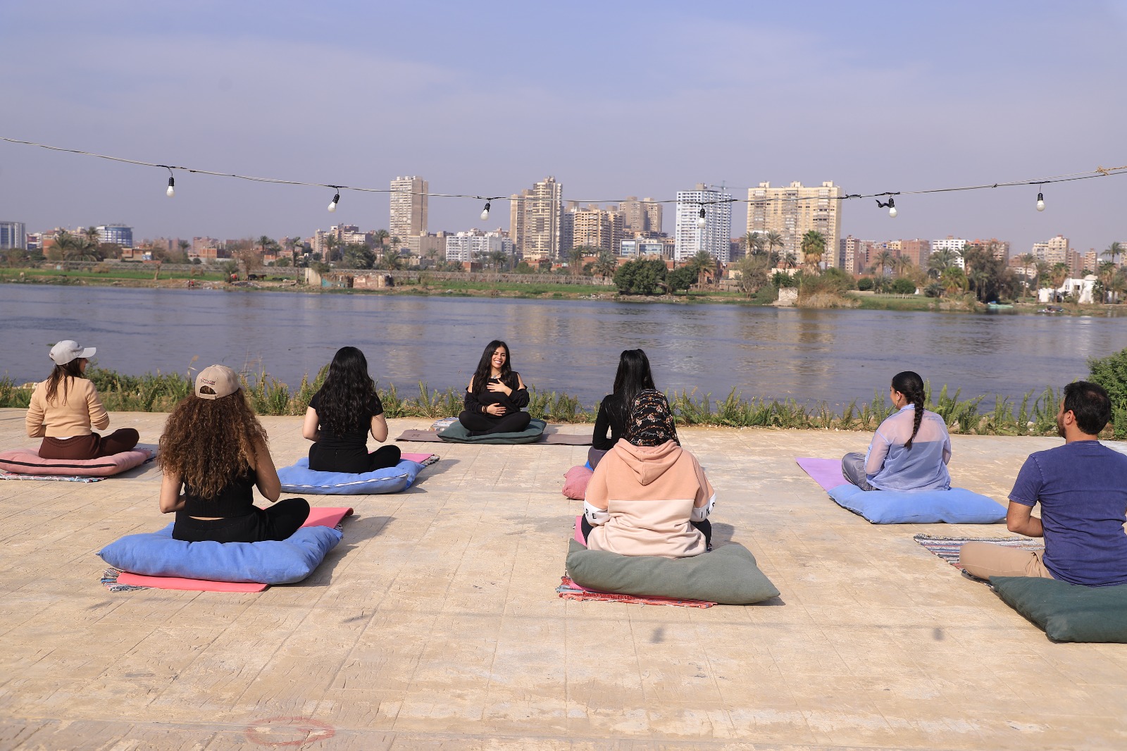 Aya with her students doing yoga at Ahimsa by the Nile river