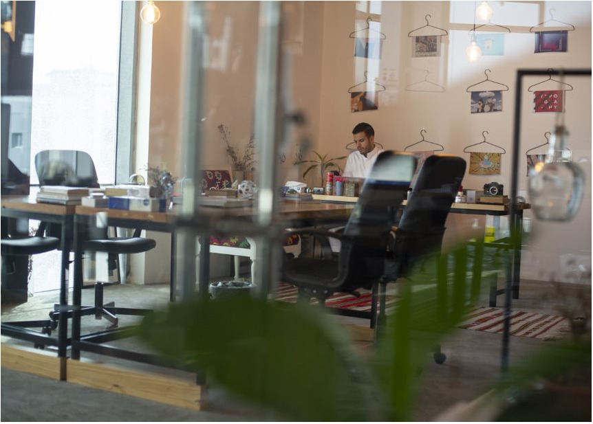 entrepreneur Faisal Sheraiff working behind a desk at his company modestudio