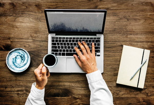 home business office man working at computer with coffee