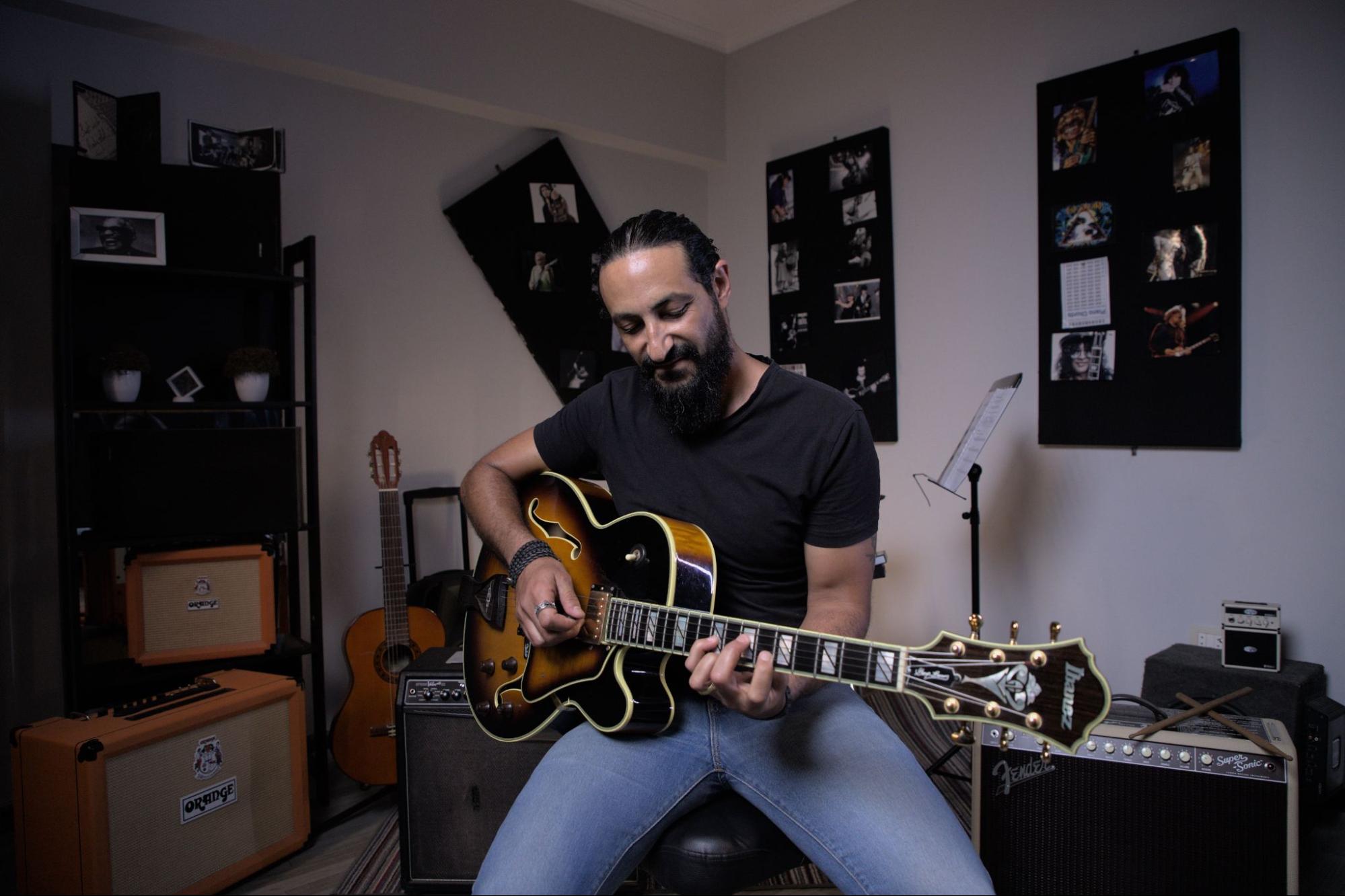 Sherif Watson, CEO of Pocket music school playing with his guitar