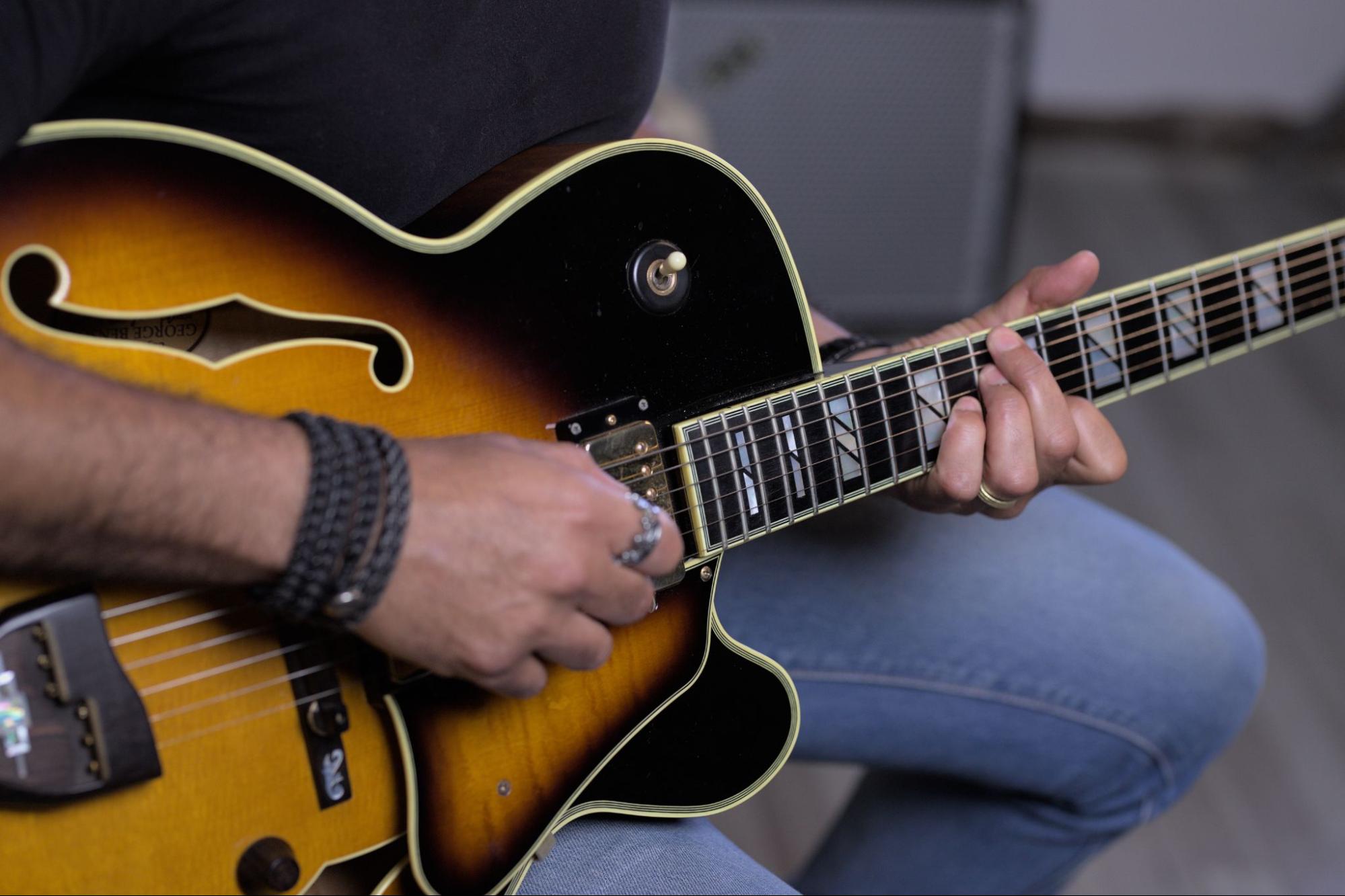 Sherif Watson, CEO of Pocket music school playing with his guitar