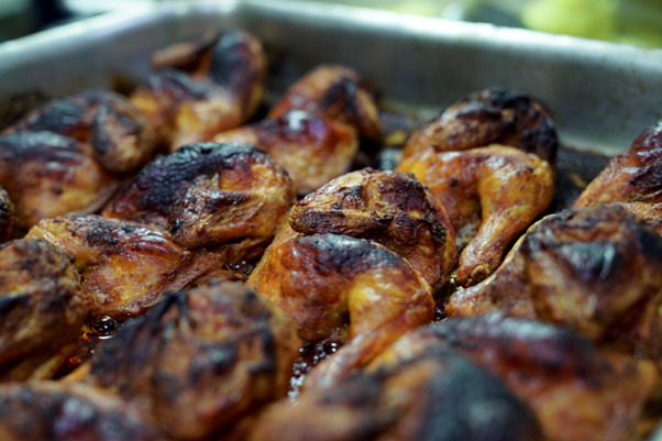 A tray of well cooked chicken at the kitchen of Qedrah w Mansaf