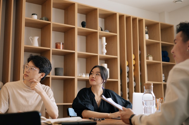 Three People In A Meeting Room