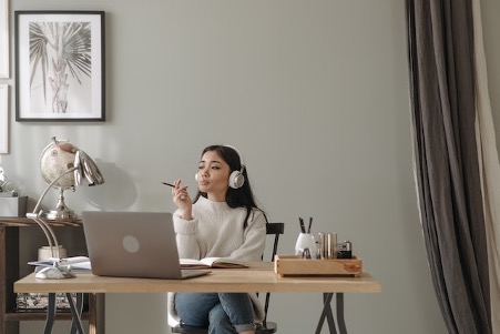 woman by laptop thinking