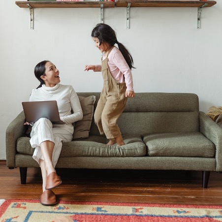 woman typing with child