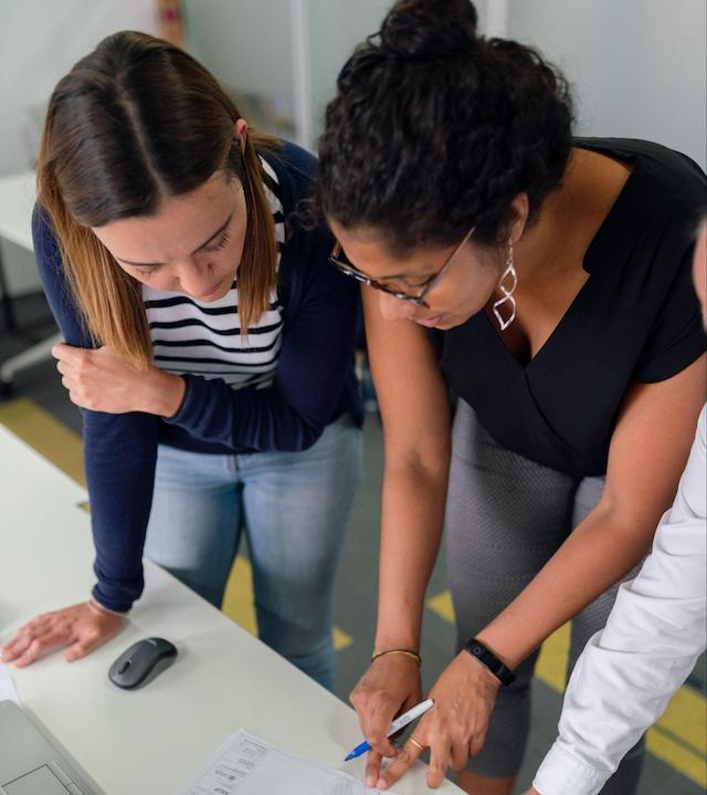 Two women looking at a document