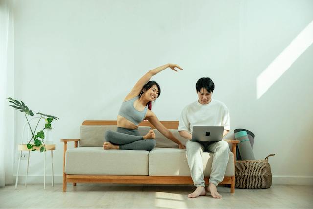 Domain Name Couple Looking At Laptop In Living Room