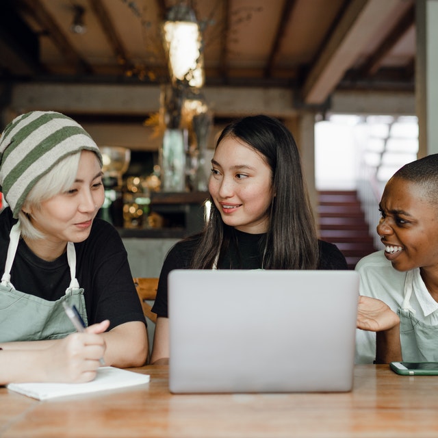 Domain Name Three Women Discussing and Smiling at Restaurant