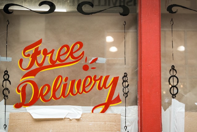 Free delivery painted on a shop window