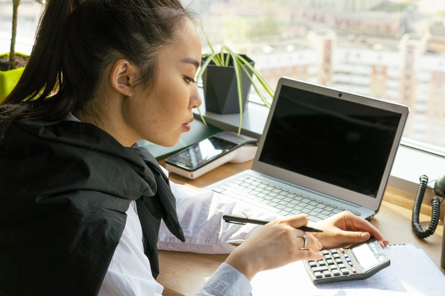 Woman At Desk With A Laptop And Doing Business Planning