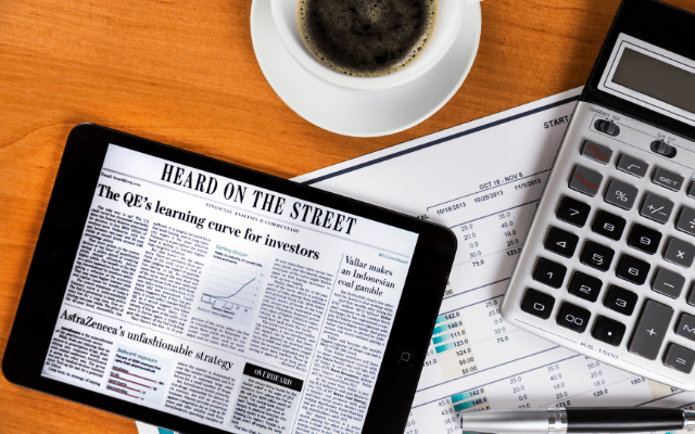 iPad Showing Newspaper Screen On Table