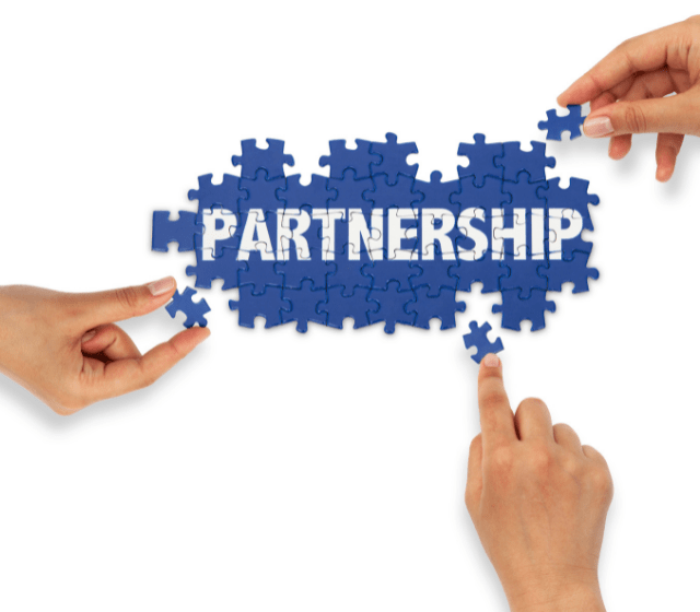 Three hands with puzzle piece forming the word partnership