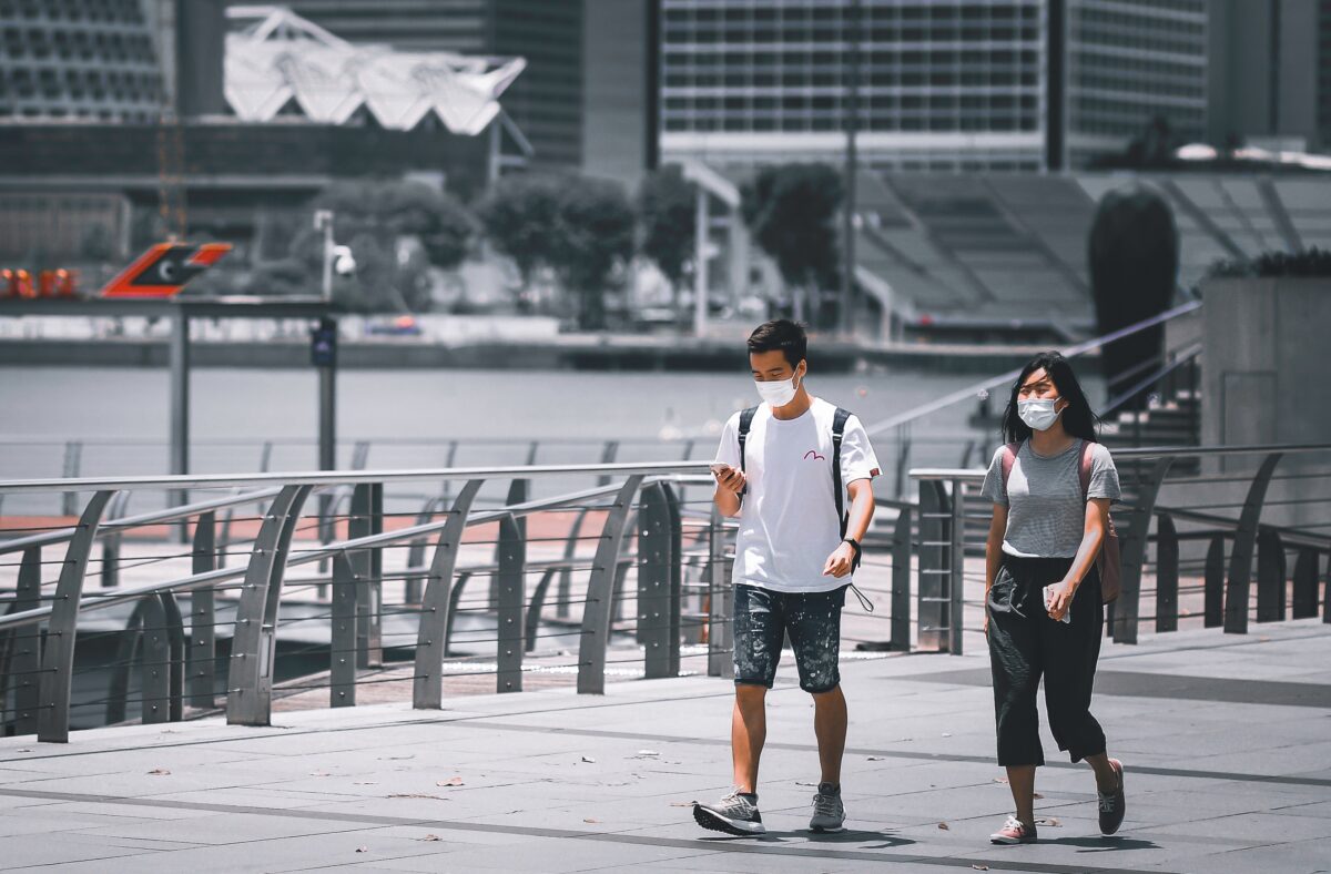 Two people walking along Marina Bay in Singapore