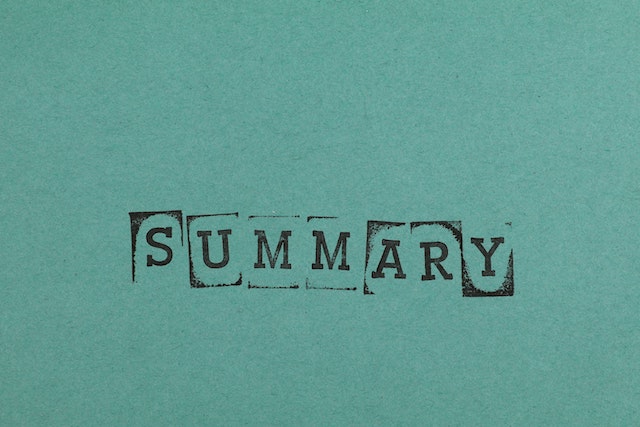 Word summary stamp on green paper