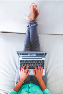 Overhead View of Woman with Her Feet Up While Using a Laptop