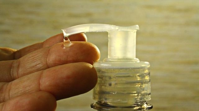 Closeup of a Hand Getting Sanitiser from a Pump