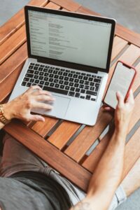 Digital Nomad Man Working at Wooden Table