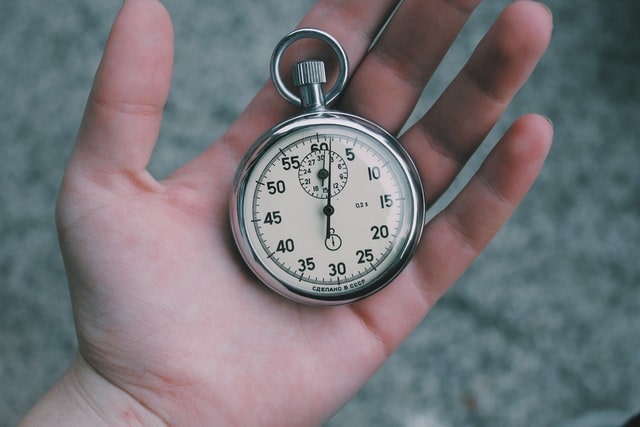 Hand holding a stopwatch