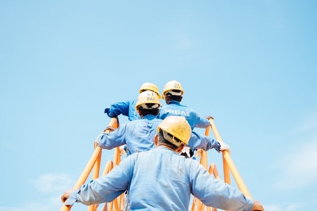 Men Wearing Yellow Construction Helmets