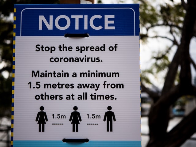 Outdoor Sign Encouraging Social Distancing