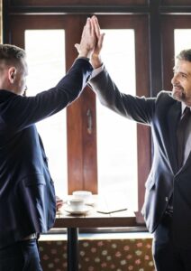 Performance Review Two Men High Five