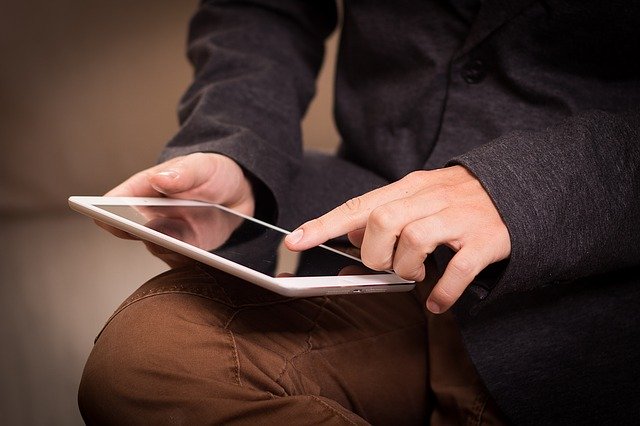 Seated Man Using a Digital Tablet