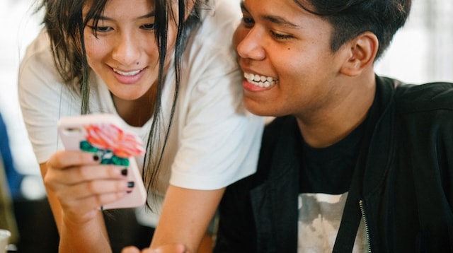 Social Media Platforms Two People Looking at Smartphone