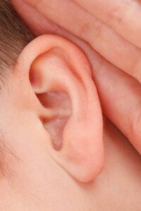 Person with Hand to Their Ear