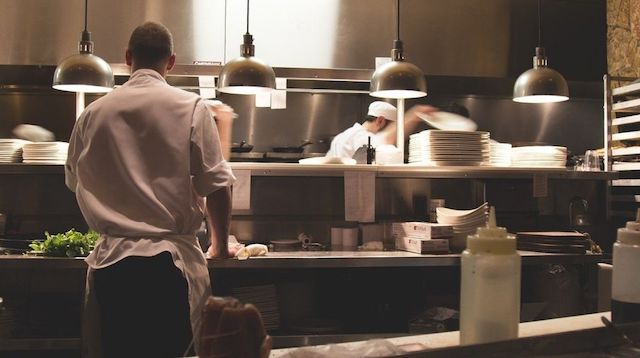 Two men working in a restaurant kitchen