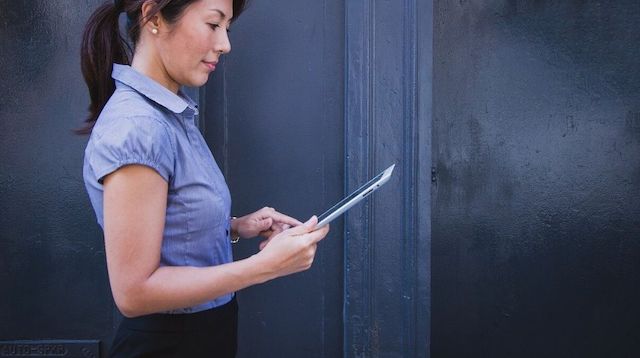 Web Design Woman Looking at Tablet