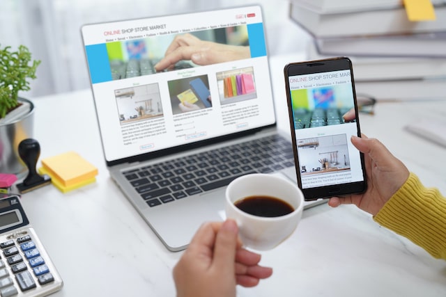 Woman Drinking Coffee While Viewing a Website on Her Phone