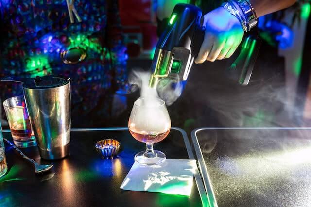 Closeup of a bartender mixing a drink