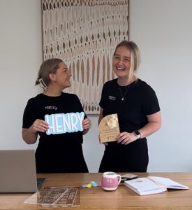 Ellie and Elyssa holding some of their products