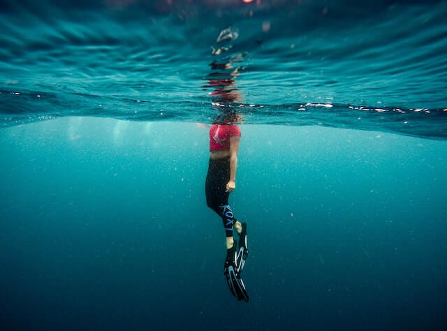 Underwater photo of a woman wearing flippers