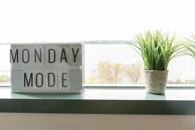 Monday mode sign sitting on a windowsill