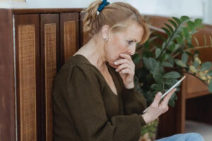 Woman looking with concern at something on her tablet