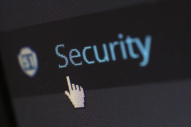 Close-up of a computer cursor pointing at the word “security”