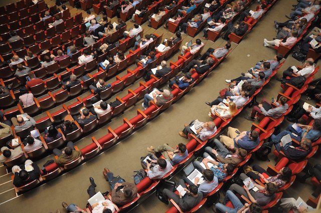 Auditorium filled with people in seats