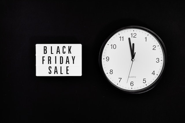 Black Friday sale sign next to a clock