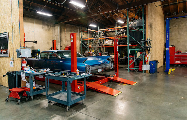 Blue vintage car in a repair shop