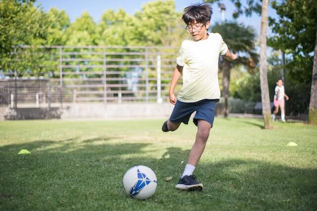 Boy kicking a football