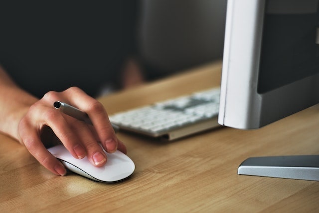 Closeup of a person’s hand on a computer mouse