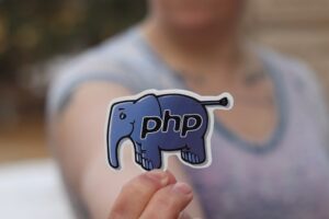 Closeup of a woman holding a PHP sticker