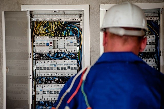 Electrician looking at a fuse box