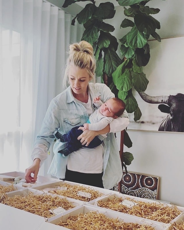 Emma packing hampers with her newborn son