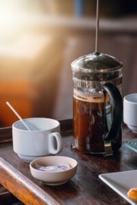 French press coffee maker on a tray